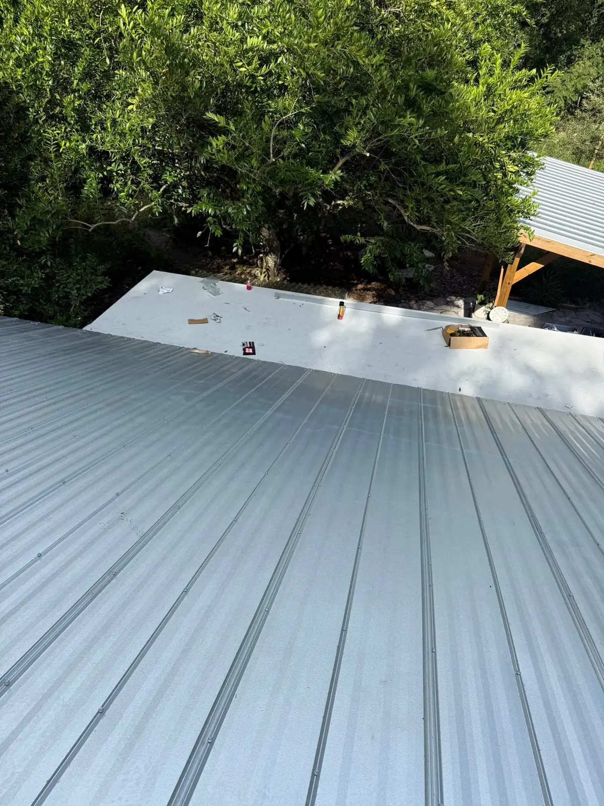 Mill finish 5V metal panels and matching drip edge on a Micanopy reroof