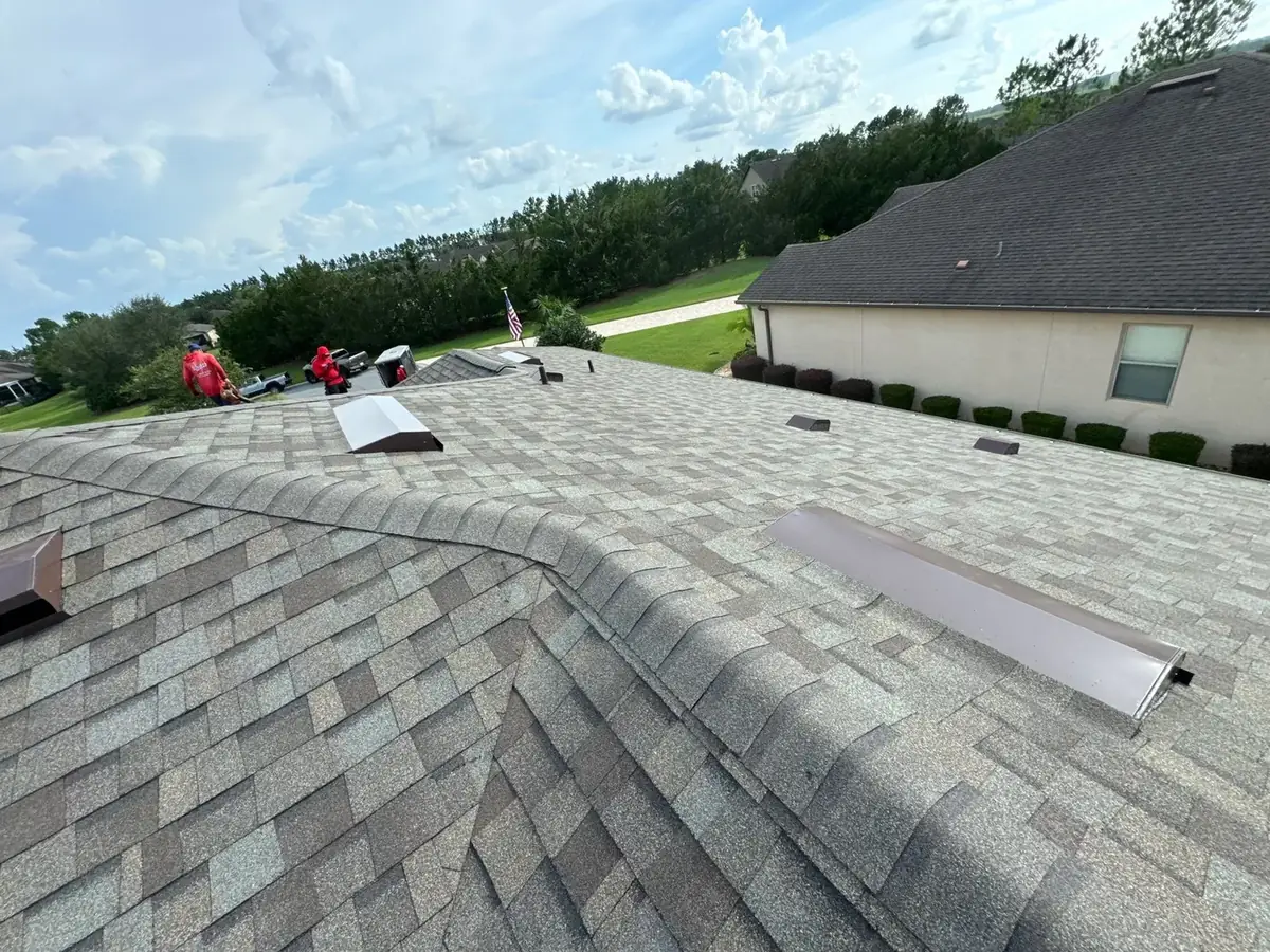 Crew installing Driftwood architectural shingles during an Ocala, FL roof replacement