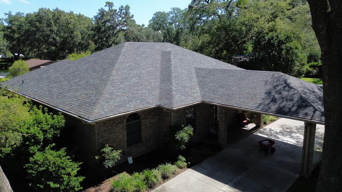 Drone view of a brick ranch home in Chiefland with a new multi-tone shingle hip roof