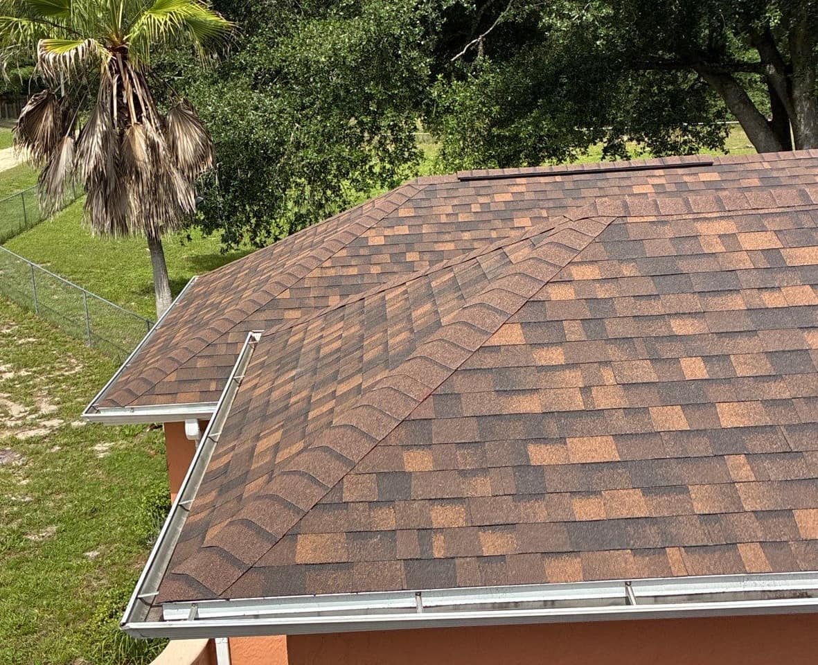 Looking down on the new brown shingle hip roof beside the front entry of a Dunnellon home