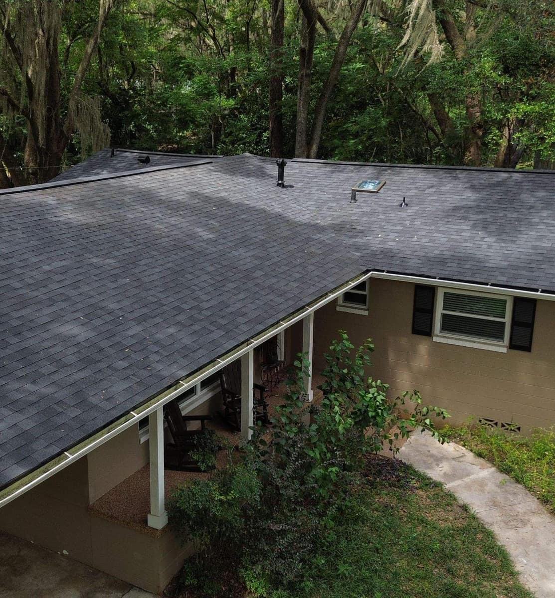 Drone view of the new near-black shingle roof over the front porch of a Gainesville ranch home