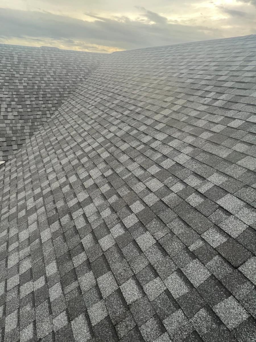 Two roof slopes meeting in a long shingled valley on the Newberry roof