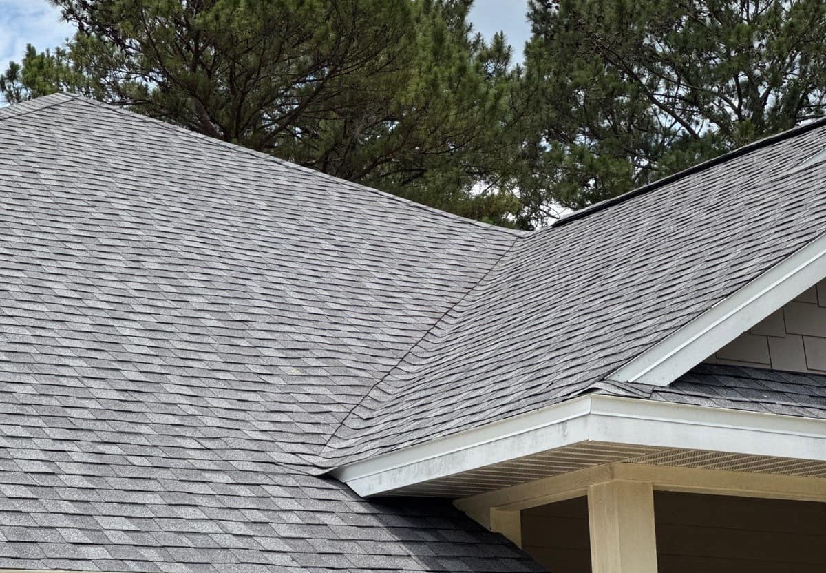 Main hip roof and front porch gable of a Newberry home in new soft gray shingles