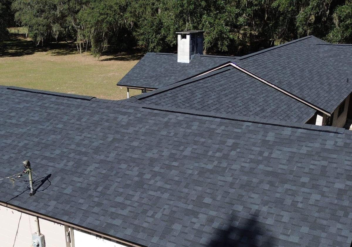 Drone view of the new gray shingle roof over the garage wing and main house in Newberry