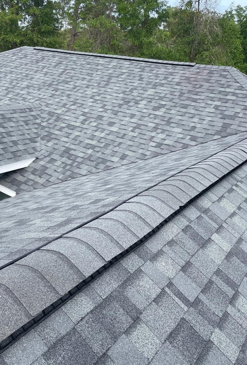 New light blue-gray architectural shingles and a capped ridge vent on a hip roof in Silver Springs