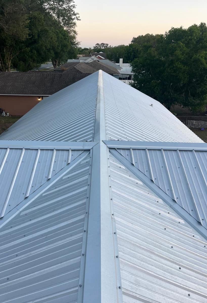 New silver metal roof on a Tavares home, seen from up top along the main ridge and hips