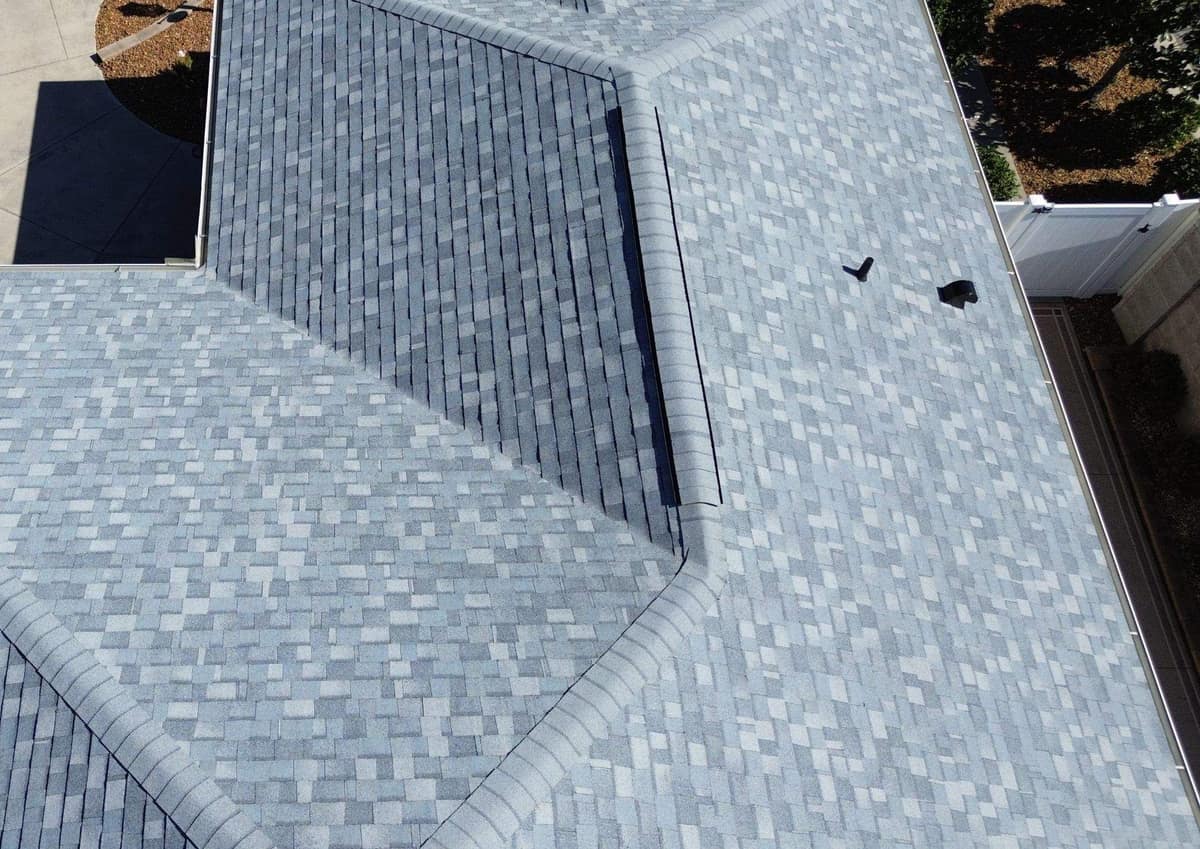 Close drone view where the front hips meet a vented ridge on the roof in The Villages