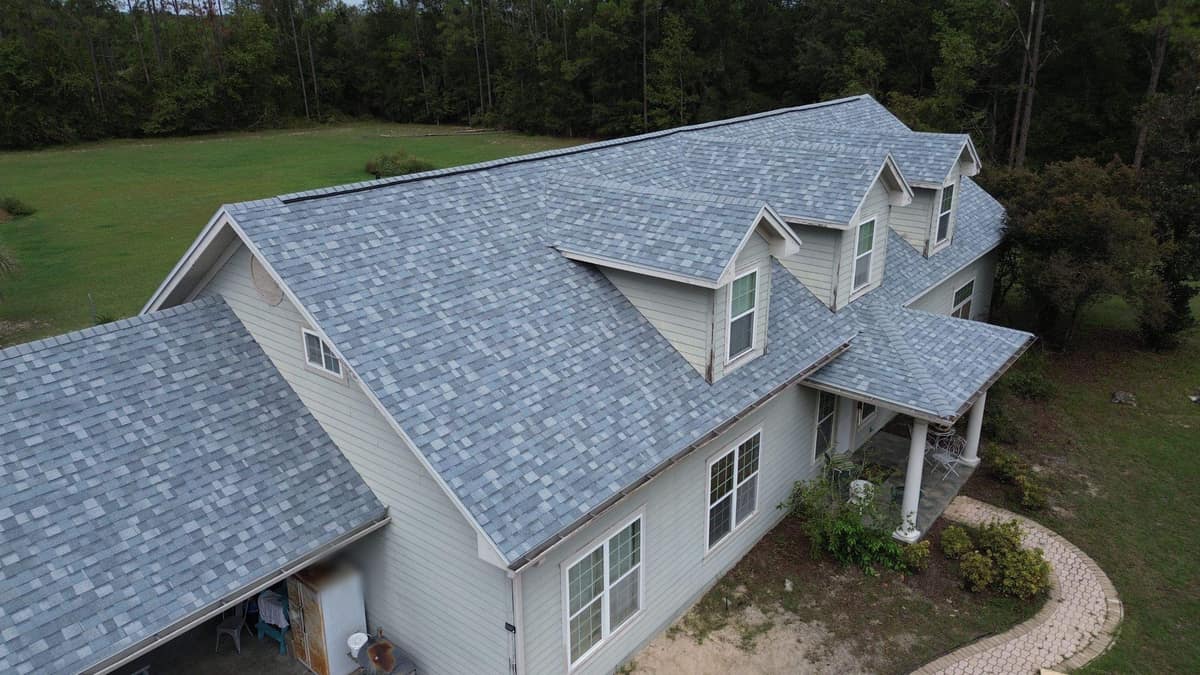 Drone view of a Trenton home with three dormers and a new blue-gray shingle roof