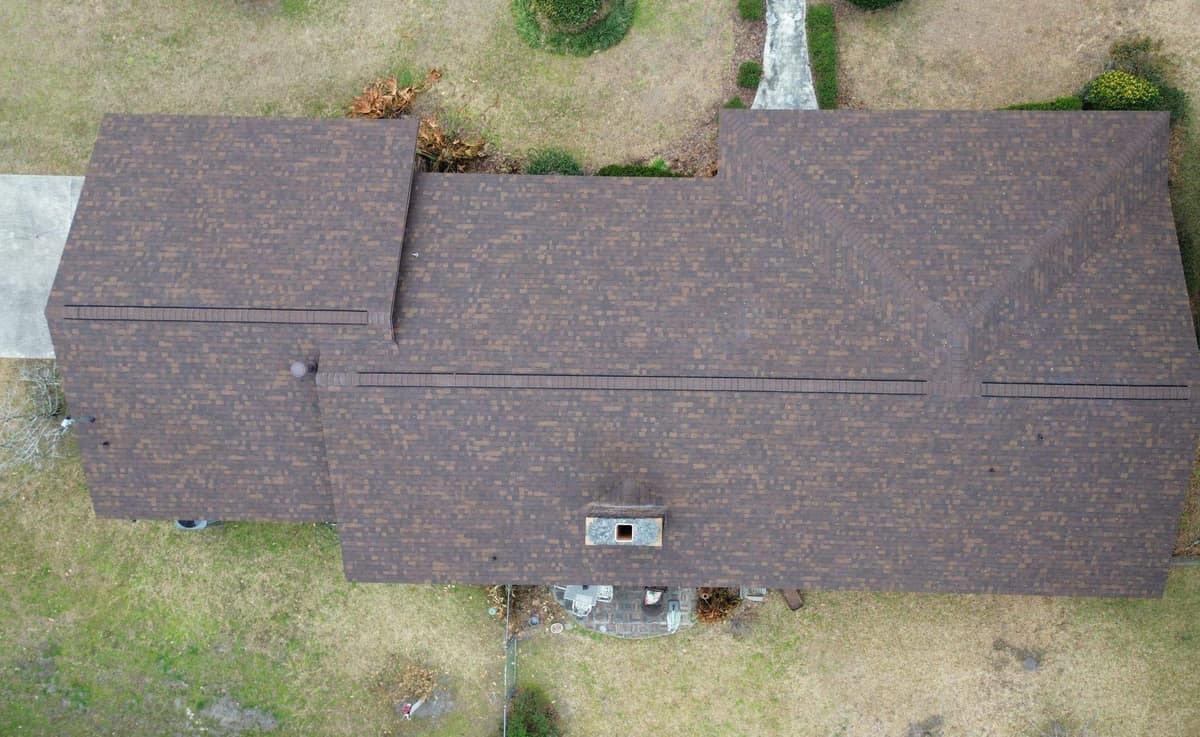 Overhead drone view of the new brown shingle roof on a ranch home in Williston