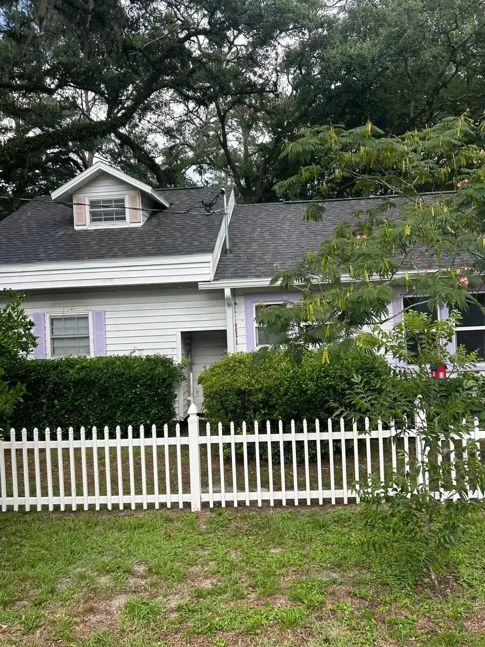 Front elevation of a house with a shingle roof in Live Oak, Florida