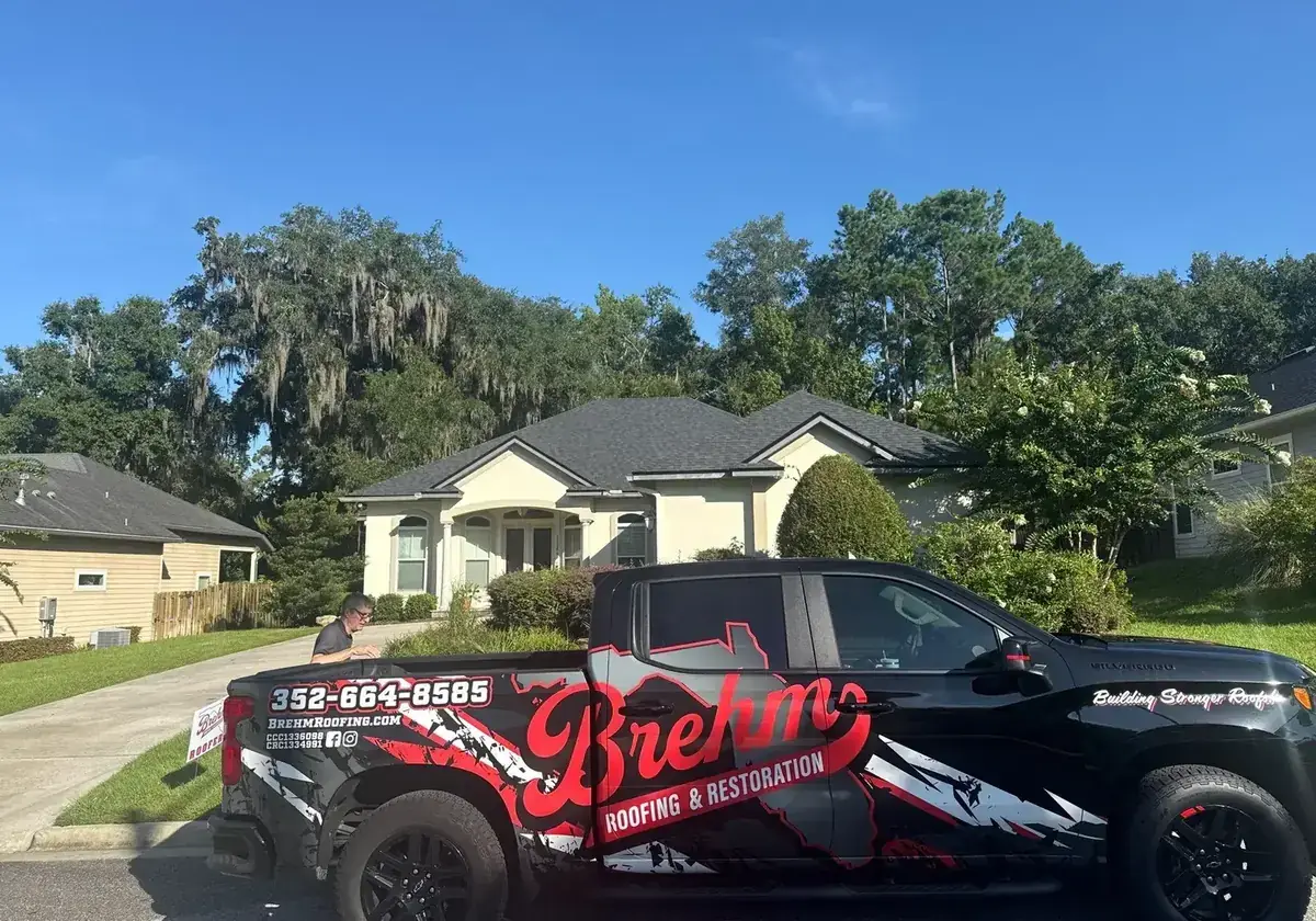 Brehm Roofing truck in front of a completed Gainesville roof