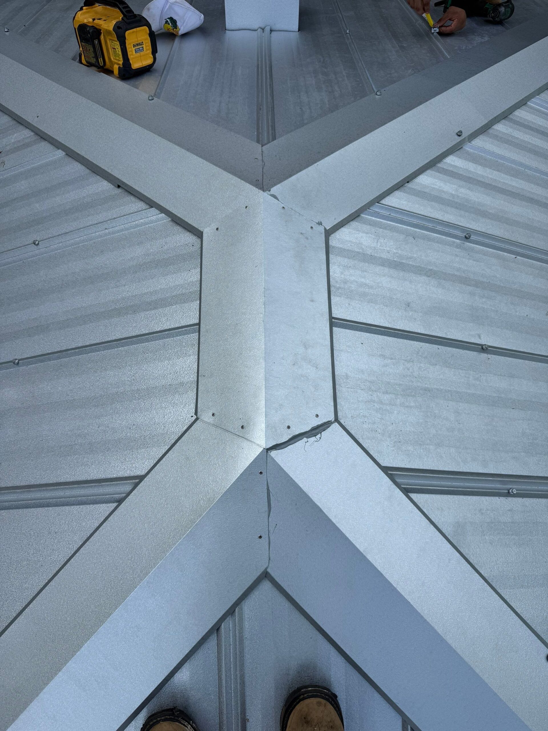 Custom 6 inch ridge caps on a mill finish 5V metal roof in Micanopy